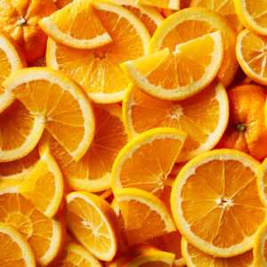 Vibrant food photography of fresh orange slices, capturing their juicy texture and bright color in a detailed close-up shot.